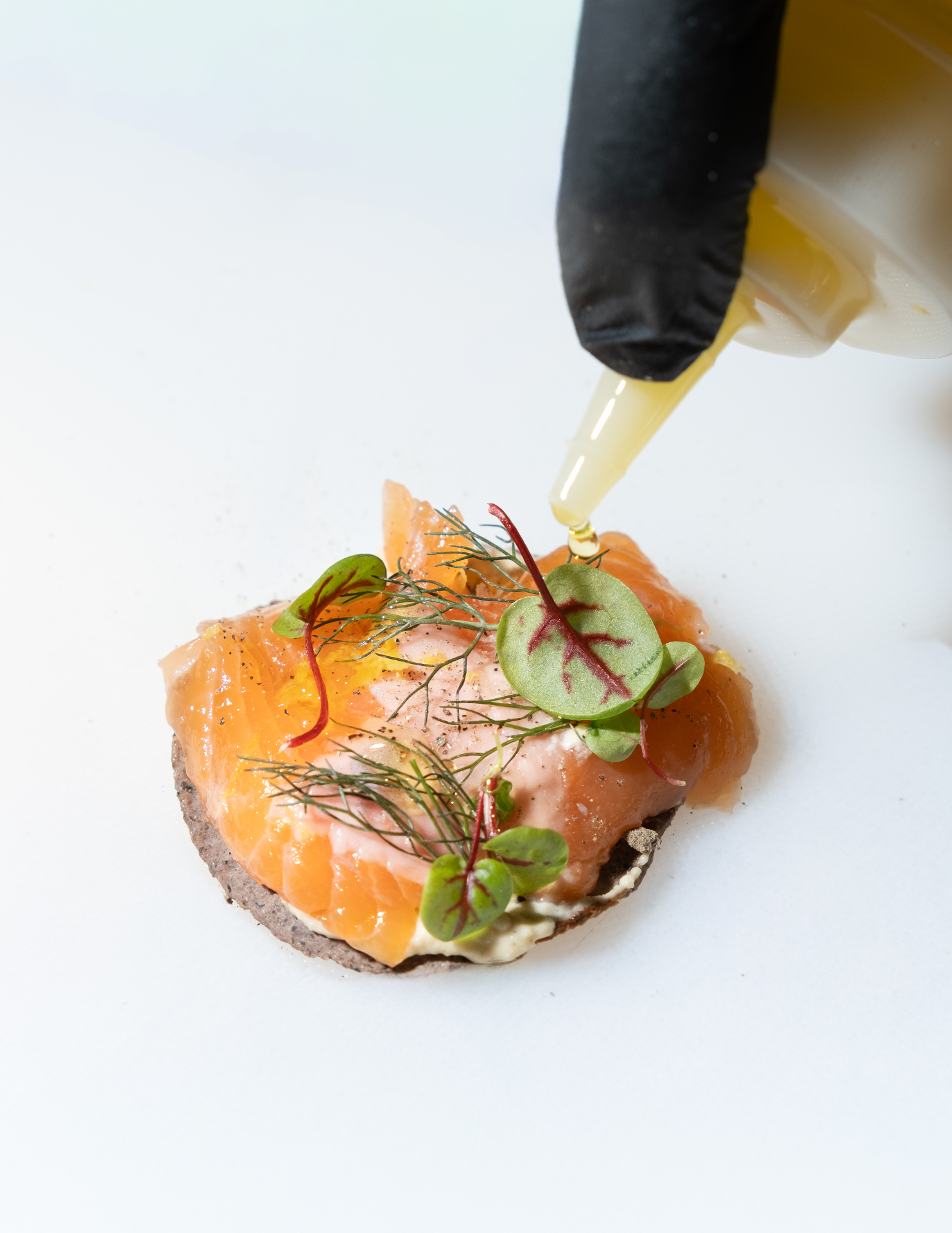 Cured salmon canapé with herbs and olive oil drizzle