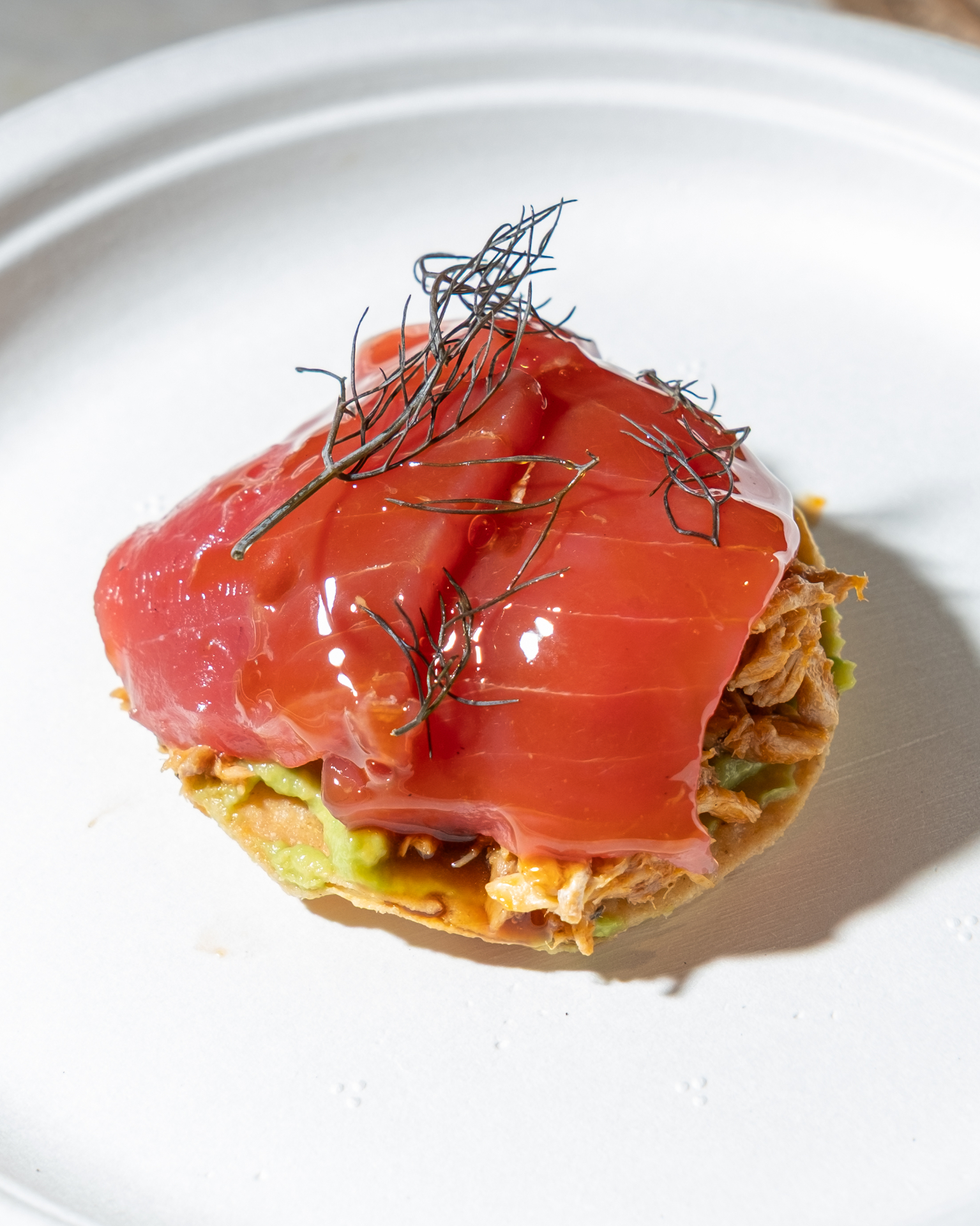 Tuna tostada with avocado and dill